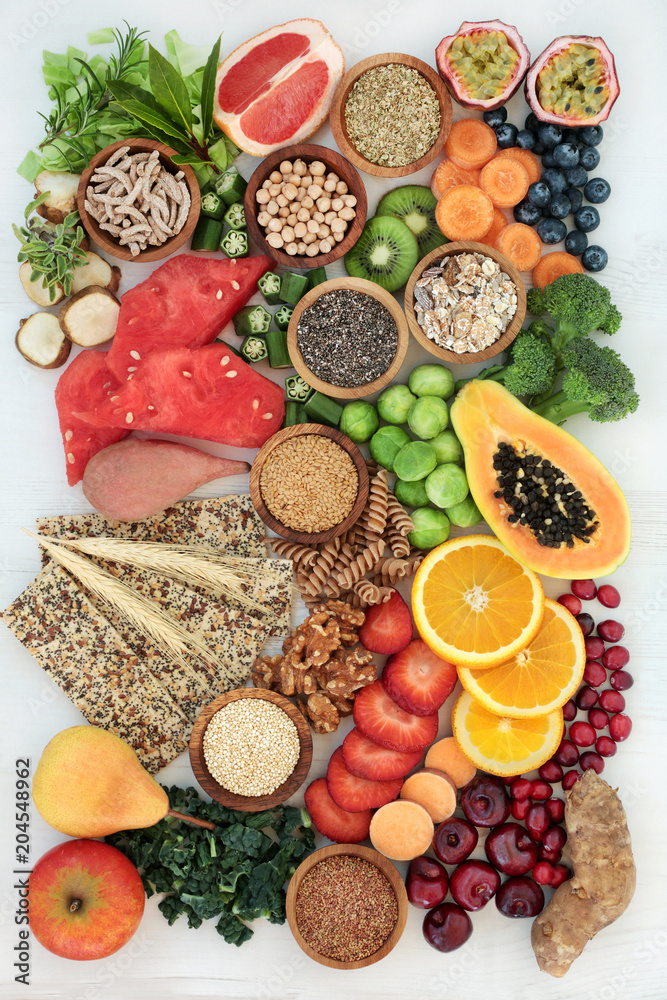 Healthy high fibre dietary food concept with fruit, vegetables, nuts, seeds, cereals, whole grain seeded crackers, whole wheat pasta & herbs. High in antioxidants, anthocyanins, omega 3 and vitamins. Healthy high fibre dietary food concept with fruit, vegetables, nuts, seeds, cereals, whole grain seeded crackers, whole wheat pasta & herbs. High in antioxidants, anthocyanins, omega 3 and vitamins.