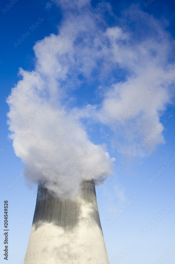 Cooling tower with water vapor over it Cooling tower with water vapor over it