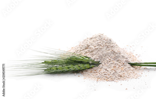 Pile of integral spelt flour with green wheat isolated on white background