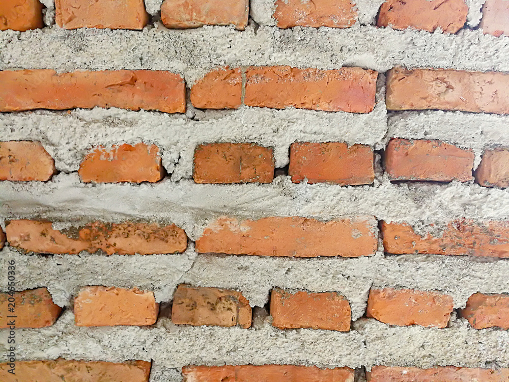 Obraz premium Orange brick wall and grey concrete texture background.