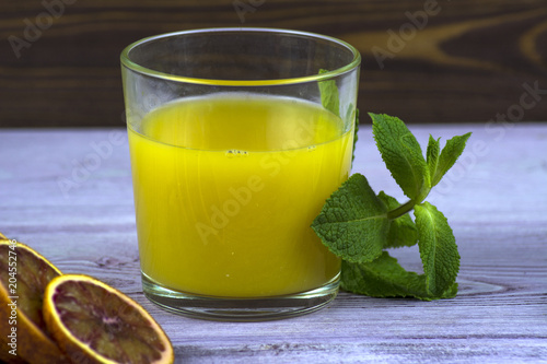 Summer drink. A glass of freshly squeezed orange juice. Sprig of mint and orange slices photo