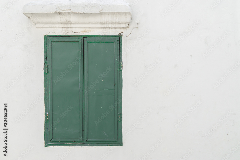 Old green window on the wall., with copy space for text.