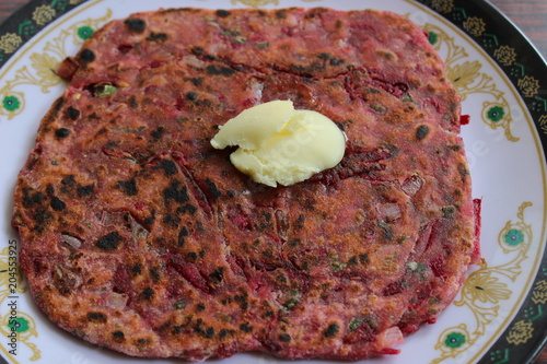 Close up of Beetroot paratha with pasteurised butter photo