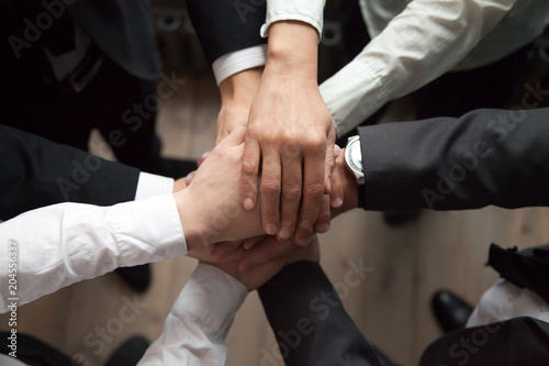 Fotografi Motivated business people put hands together, sales team engaging in teambuildin