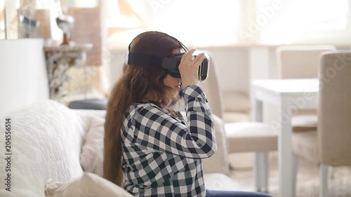 Young woman using Virtual Reality headset photo