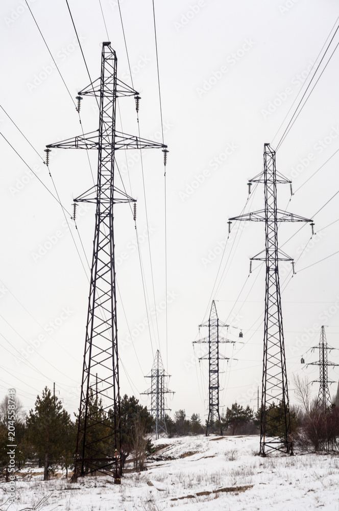 Electricity pylons and power lines in the winter day Electricity pylons and power lines in the winter day