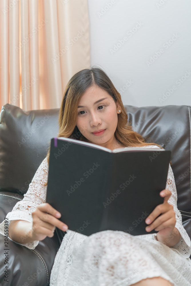 Asian pregnant woman read a book at home,Study of how to raise children,Thailand people Asian pregnant woman read a book at home,Study of how to raise children,Thailand people