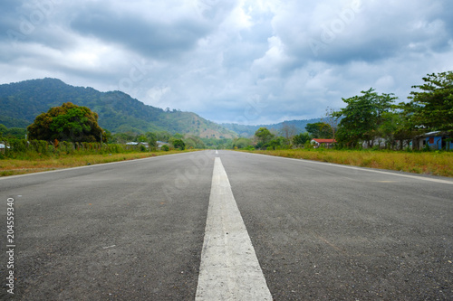straight asphalt road in rural landscape - empty runway © hanohiki