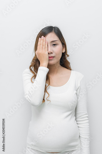 A pregnant woman in white dress stand pose for take a picture on white background