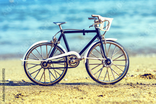 Daylight view to handicraft bicycle souvenir on sand