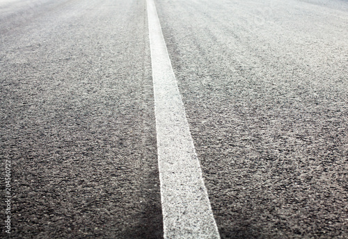 Unbroken white road marking line © rootstocks