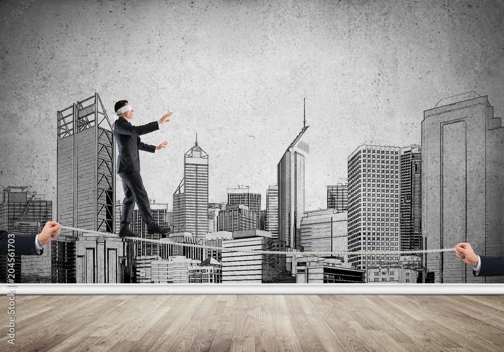 Business concept of risk support and assistance with man balancing on rope Business concept of risk support and assistance with man balancing on rope