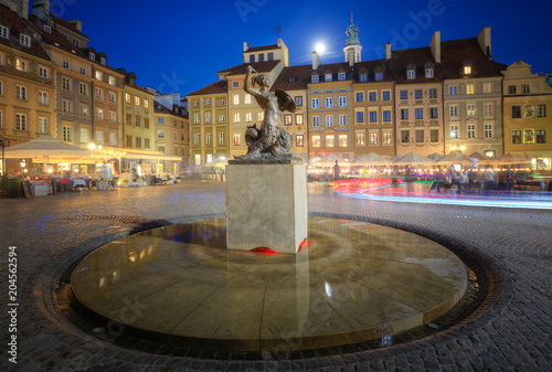 Statue of a mermaid in the old town at night. Warsaw, Poland.