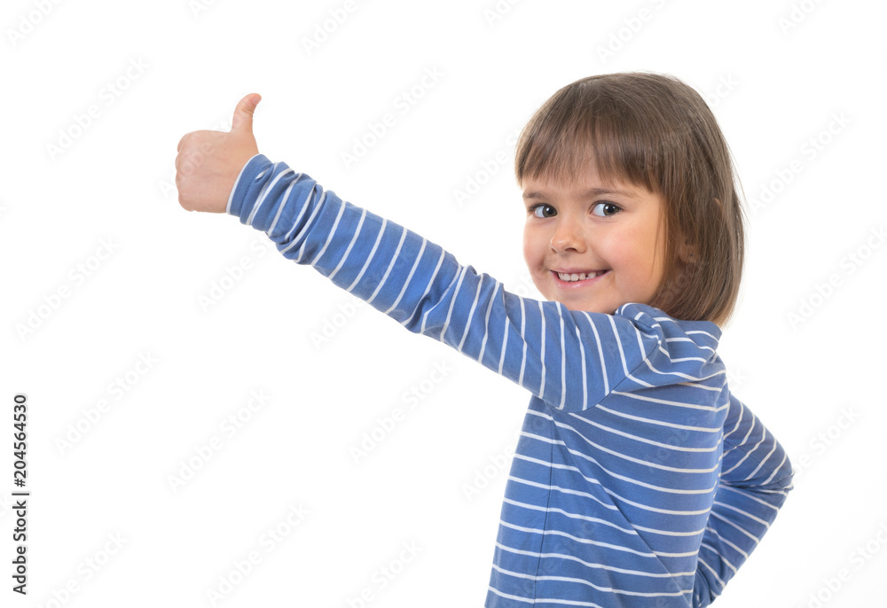 A little kid pointing with her thumb up and showing a copy makes spaces for posting your information against the white background. A little kid pointing with her thumb up and showing a copy makes spaces for posting your information against the white background.