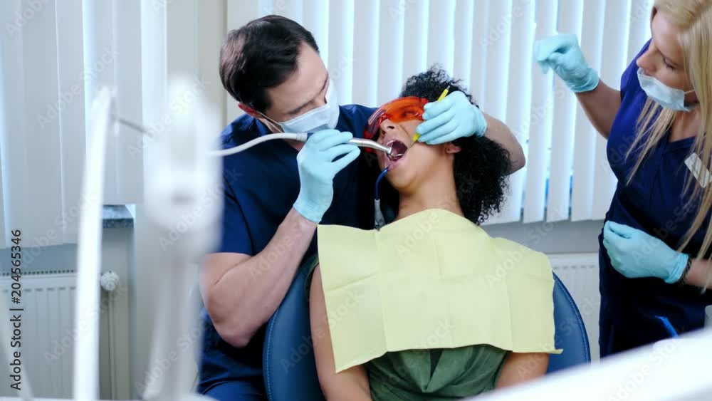 Dentist and his assitant working in private practice. Dentist and his assitant working in private practice.