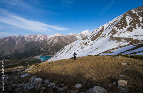 a man with a book in the mountains