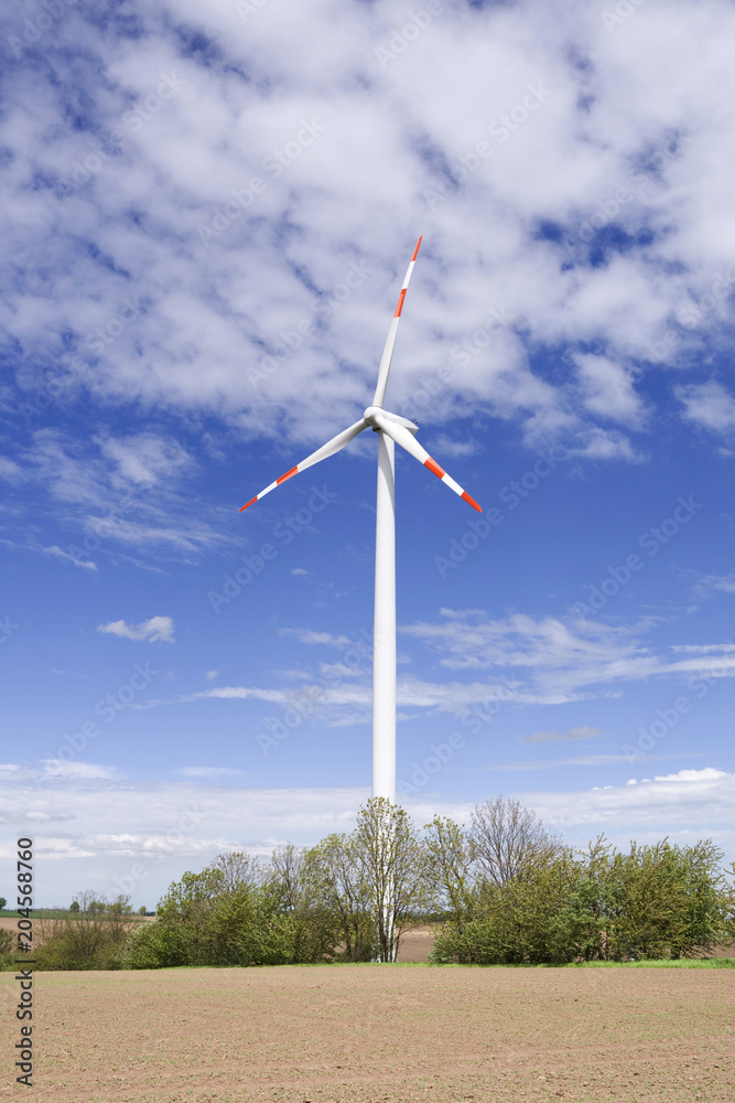 Wind Energy: Modern three bladed wind turbine in the rural East Thuringian landscape on a beautiful day in April Wind Energy: Modern three bladed wind turbine in the rural East Thuringian landscape on a beautiful day in April