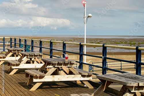 Cafe with rustic wooden tables on pier in Southport, Britain