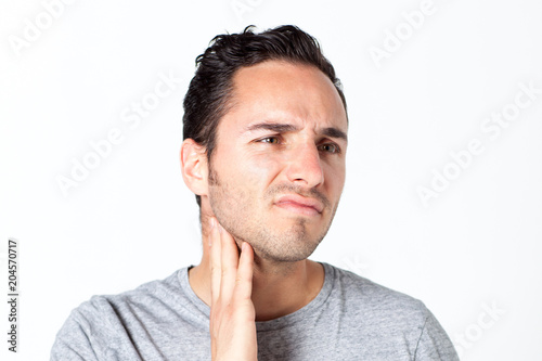 Man in gray T-shirt with toothache 