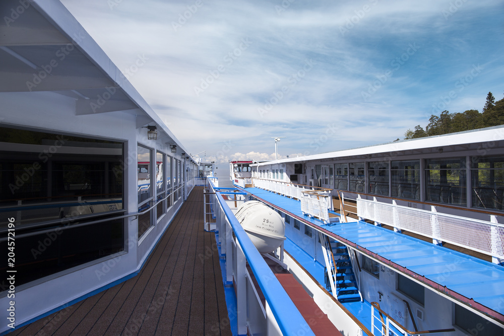 Passenger ships at the pier. Walking decks, lit by the sun. Passenger ships at the pier. Walking decks, lit by the sun.