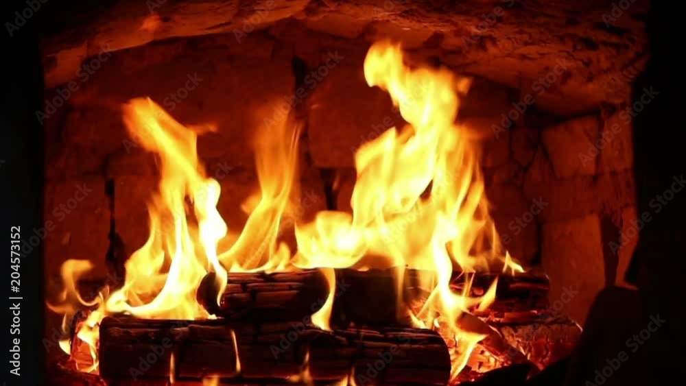 Firewood and fire flames in fireplace, bonfire close-up. Firewood and fire flames in fireplace, bonfire close-up.