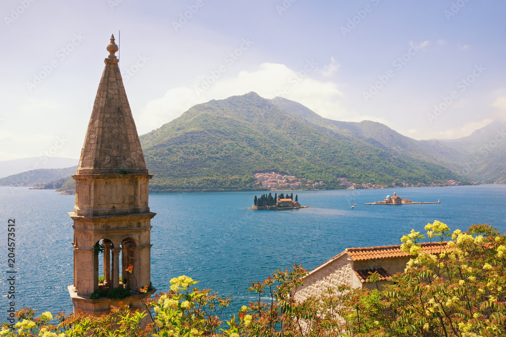 Fototapeta premium Beautiful Metiterranean landscape. Montenegro. View of Bay of Kotor with two small islands and bell tower of the Church of Our Lady of Rosary in Perast town. Travel and tourism concept