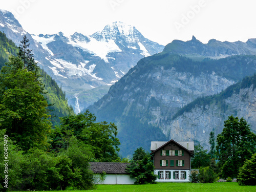 Switzerland, Lauterbrunnen, SCENIC VIEW OF SNOWCAPPED MOUNTAINS AND TREES DURING WINTER © SkandaRamana
