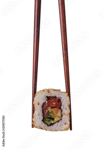Sushi roll in chopsticks isolated on white