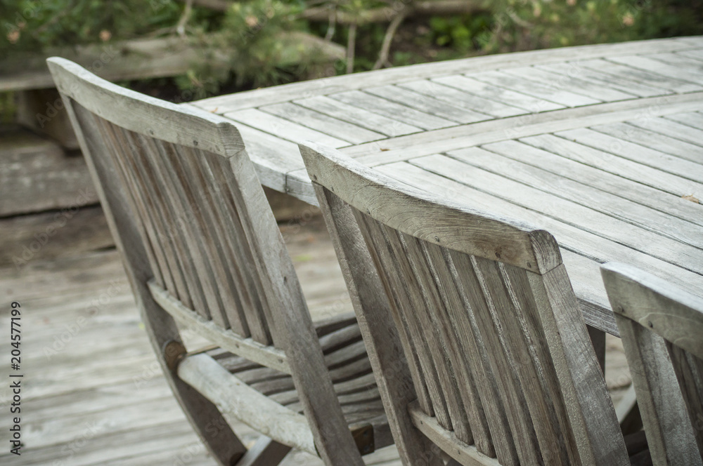 closeup of Teak garden furniture on a wooden terrace in spring