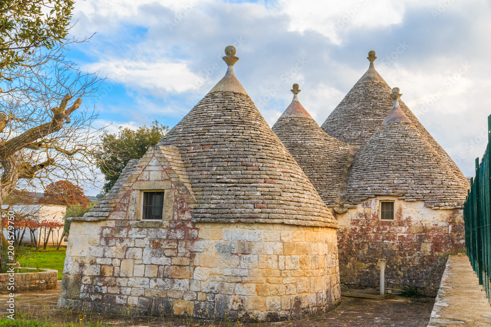 Italy, SE Italy, Region of Apulia, Province of Bari, Itria Valley, Alberobello. A trullo house is a Apulian dry stone hut with a conical roof. UNESCO Heritage site. November 24, 2016 Italy, SE Italy, Region of Apulia, Province of Bari, Itria Valley, Alberobello. A trullo house is a Apulian dry stone hut with a conical roof. UNESCO Heritage site. November 24, 2016