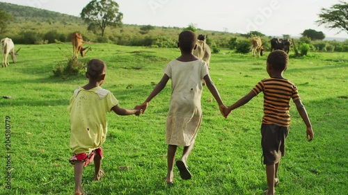 Wallpaper Mural Children holding hands and walking on a field Torontodigital.ca