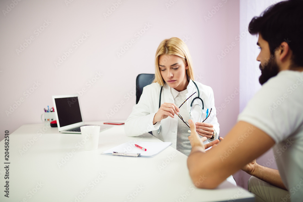 Female doctor at medical office discussing results with patient Female doctor at medical office discussing results with patient