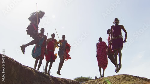 Maasai people performing a jumping dance photo