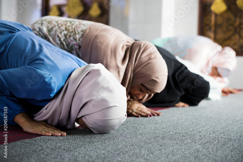 Muslim women praying in the mosque during Ramadan