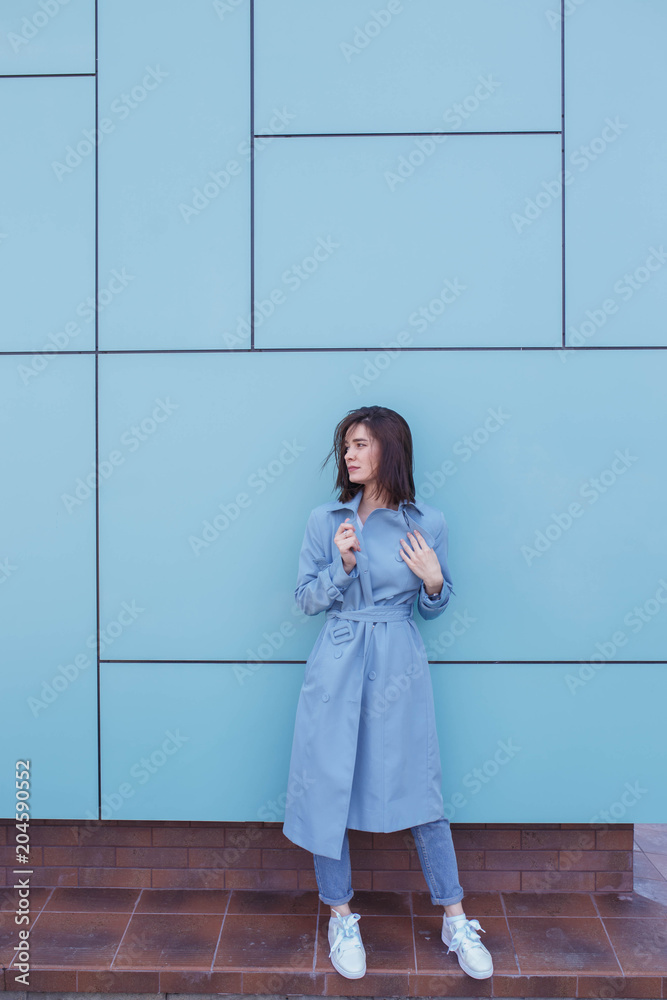 Attractive young woman on a turquoise background. Attractive young woman on a turquoise background.