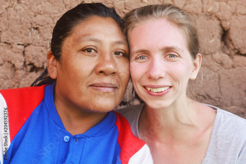 Two happy friends - caucasian woman and native american woman. Interracial friendship.