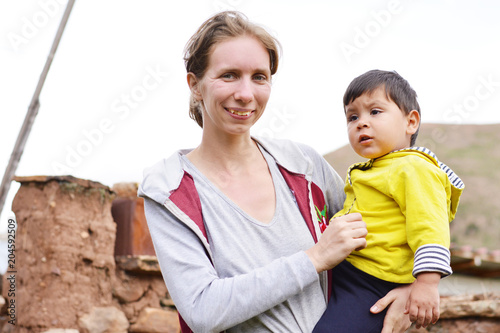Happy caucasian woman with her sad latin son in the countryside.