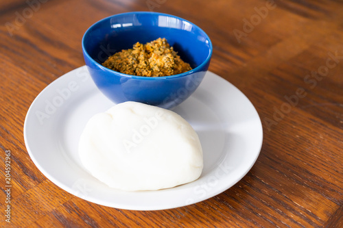 Nigerian Pounded Yam Served with Egusi soup in Blue Bowl
