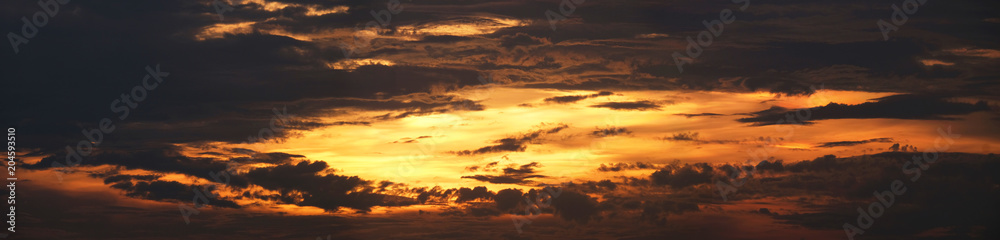Silhouette of clouds during sunset in panorama aspect ratio