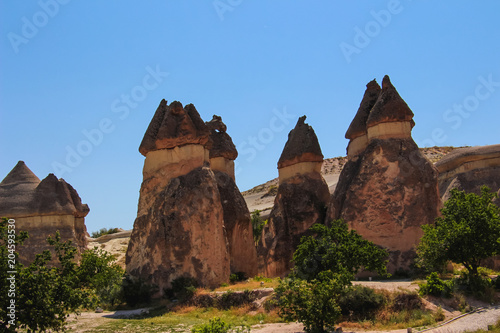 fairy chimneys with cones in cappadocia valley