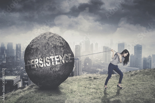 Young businesswoman pulling persistence word