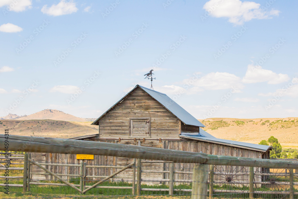 Farm home or building in rural midwest landscape. Summer day setting in Montana, USA.