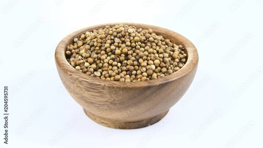 Coriander seeds in wood bowl on white rotation
Coriander seeds in wood bowl on white rotation