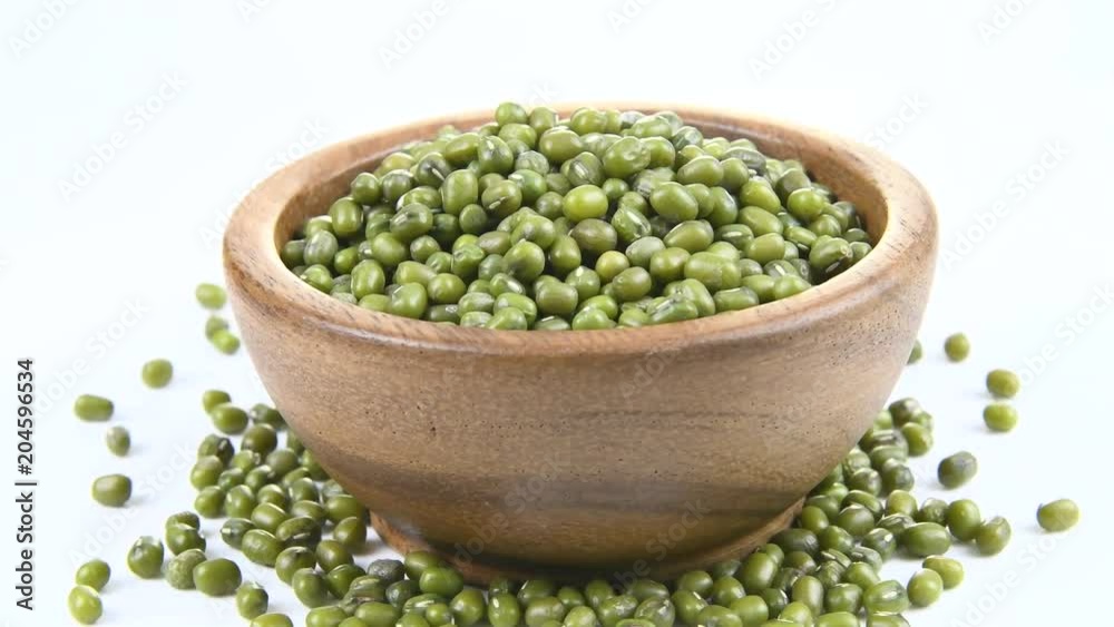 green beans in wood bowl on white. rotation green beans in wood bowl on white. rotation