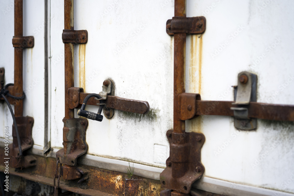 Old rusted door closing mechanism of the semi trailer with digital lock