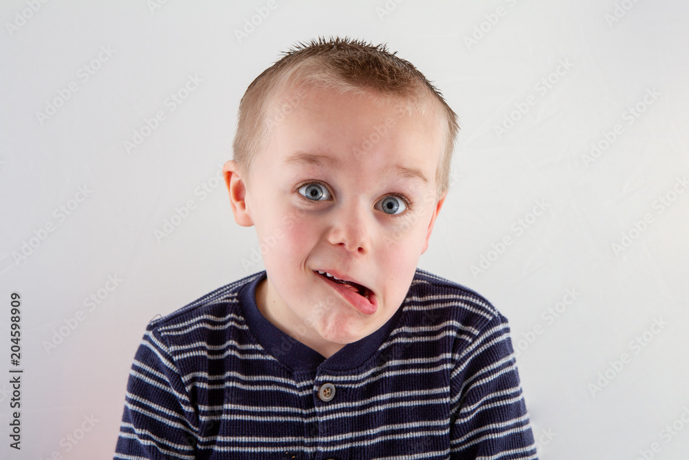 boy making a funny face at the camera boy making a funny face at the camera