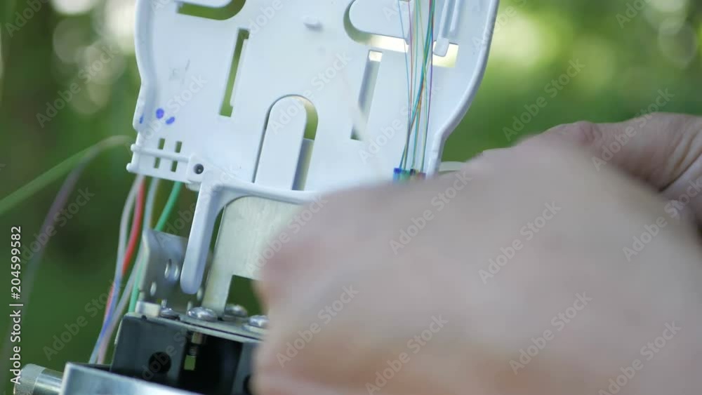 Technicians are installing optic fiber with cable ties.