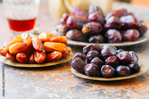 Set of various of dried dates or kurma in a vintage plates. photo