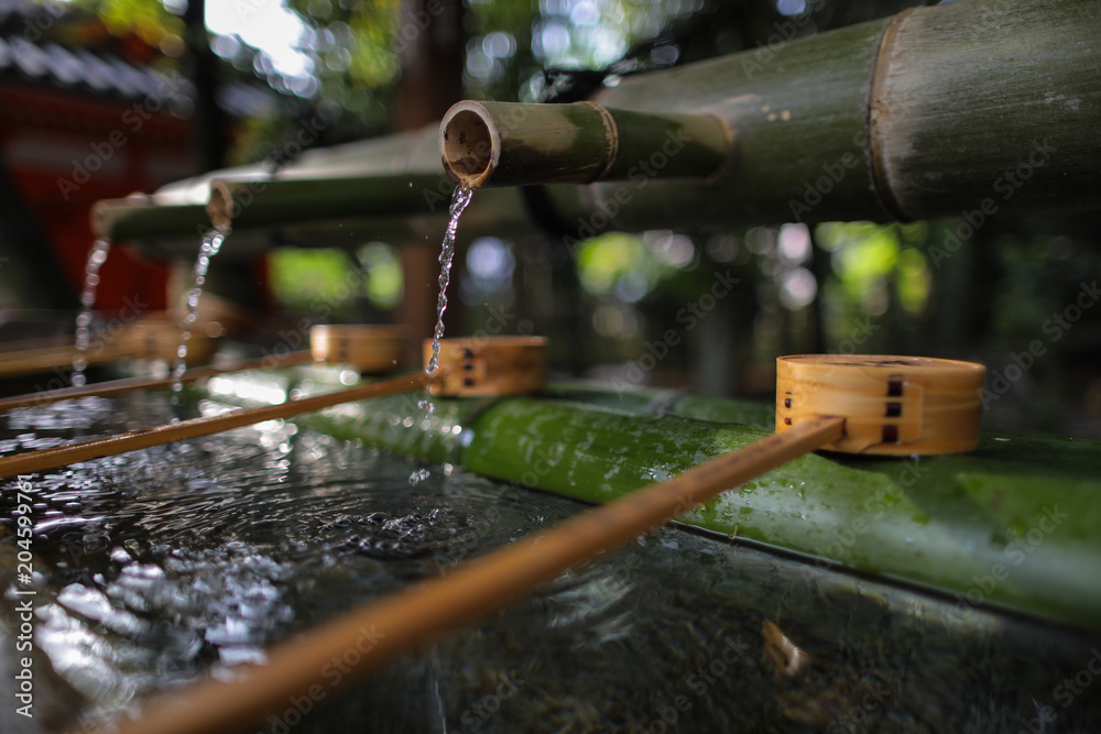 Water from bamboo and Water bamboo bowl for cleaning hand and mouth before worship in temple and shrine in Japan. Water from bamboo and Water bamboo bowl for cleaning hand and mouth before worship in temple and shrine in Japan.