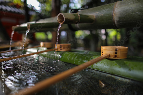 Water from bamboo and Water bamboo bowl for cleaning hand and mouth before worship in temple and shrine in Japan.
